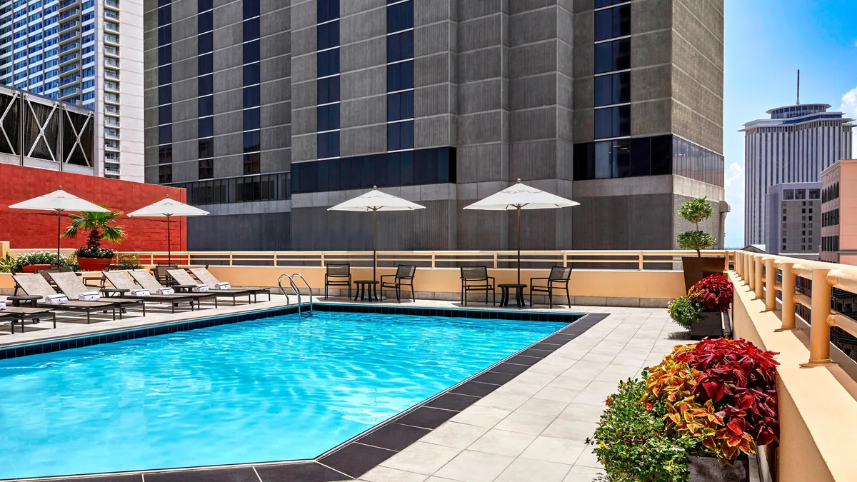 Rooftop pool deck with loungers and umbrellas